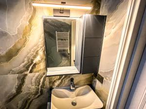 a bathroom with a sink and a mirror at Hotel Nika in Batumi +57 photos