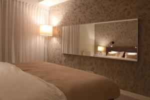 a bedroom with a large bed and a mirror at Super-Apartamenty VIP in Poznań +44 photos