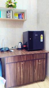 a microwave sitting on top of a wooden counter at Australia villa fully Ac Fridge Tv Wifi in Bathinda