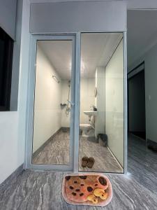 a bathroom with a large glass window and a sink at Mayhome in Long Biên
