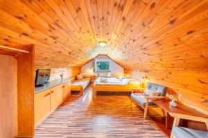 a living room with a large wooden ceiling at Pension Kubát in Špindlerův Mlýn