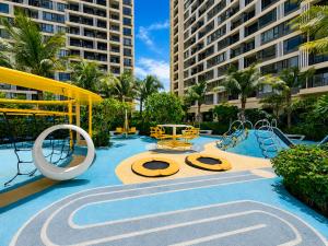 a pool with a playground in a resort at Pinnacle Moments Residence in Phnom Penh