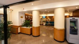 a lobby with two large columns in a building at Marko Polo Hotel in Aksay