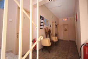 a hallway with chairs and a staircase in a house at Ulrika in Egina