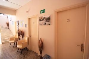 a room with a door and a table and chairs at Ulrika in Egina