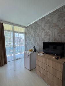 a living room with a flat screen tv on a wall at Apart hotel Gallery L in Sunny Beach