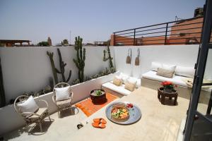 a balcony with a bowl of food on a table at Riad Sahara - Private House Rooftop Medina Marrakech in Marrakesh