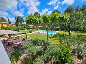 an image of a garden with a swimming pool at Les Sables d'Ocre & SPA in Roussillon
