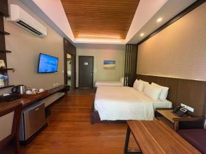 a hotel room with a bed and a tv at Aonang Hill Krabi-SHA Extra Plus in Ao Nang Beach
