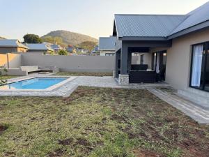 a house with a swimming pool in the yard at Natures Nest with Mongi Hazyview in Hazyview