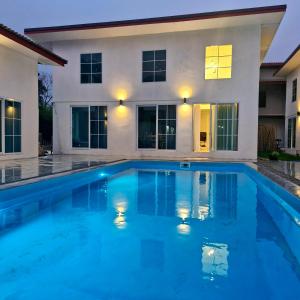 a swimming pool in front of a house at River View Villas in Vang Vieng