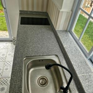 a sink in a counter next to a window at River View Villas in Vang Vieng +5 photos