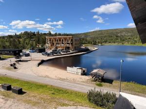 a view of a river with a dock and a building at Bortelidseter in Åseral