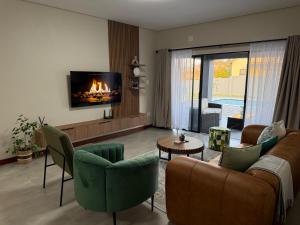 a living room with a couch and a fireplace at Natures Nest with Mongi Hazyview in Hazyview