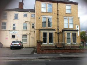 a house with a car parked in front of it at Viking Guest House in Bridlington