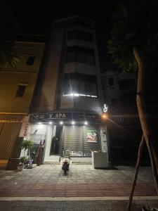 a building at night with a fire hydrant in front at Mayhome in Long Biên