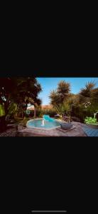 a small swimming pool in a yard with palm trees at Casita Limón Andratx in Andratx