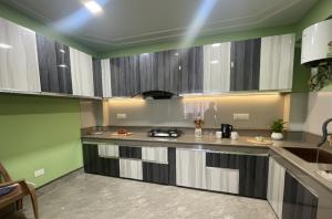 a kitchen with a counter top and a sink at Tilanjali Stay in Soreng +11 photos