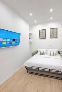 a bedroom with a bed and a flat screen tv at Studio Parking privé in Guéret