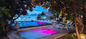 a swimming pool with pink lighting in a backyard at Papillon Resort in Chaweng