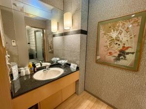 a bathroom with a sink and a mirror at Hotel Shuyukan (Adult Only) in Izumi-Sano +35 photos