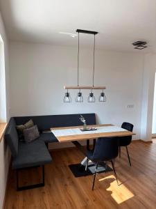 a dining room with a table and a couch at FEWO-TomKO in Fügenberg