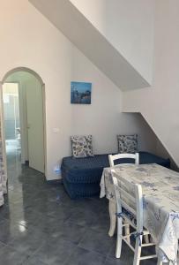 a living room with a table and a couch at L'angolo blu in Marettimo