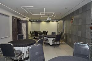 a conference room with tables and chairs in it at Hotel Ganesh Mahalakshmi Inn in Guntūr