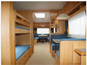 a small room with bunk beds and a table at Hobby 750 caravan in Oslo