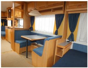 a dining area in an rv with a table at Hobby 750 caravan in Oslo