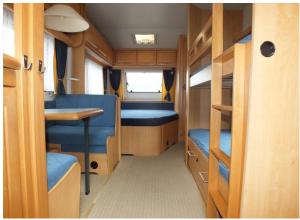 a small room with a table and chairs in a van at Hobby 750 caravan in Oslo