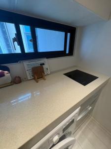 a kitchen with a counter with a toilet and a window at 大吉子溫泉民宿 in Yü-shih-ts'un +16 photos