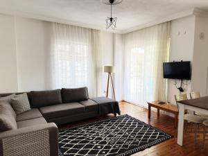 a living room with a couch and a table at KAŞ MERKEZ İMREN APART 2 in Kaş