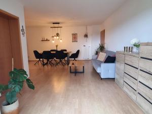 a living room with a table and a couch at Modernes Apartment mit Terasse in Lügde