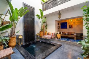 an indoor pool in a room with plants at Marrakech Medina - Private Riad 4 rooms Rooftop and pools in Marrakesh
