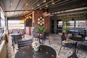 a restaurant with tables and chairs and windows at Sirkeci Ersu Hotel & SPA in Istanbul