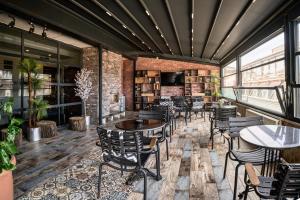 a restaurant with tables and chairs and a brick wall at Sirkeci Ersu Hotel & SPA in Istanbul