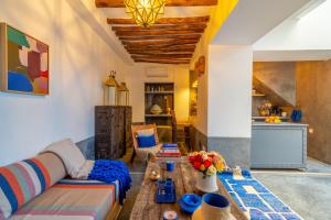 a living room with a couch and a table at Marrakech Medina - Private Riad 4 rooms Rooftop and pools in Marrakesh