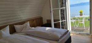 a bedroom with a bed in front of a window at Gästehaus Seeblick in Langenargen