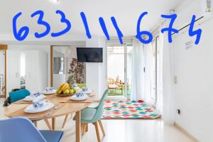 a room with a table and chairs and a sign at Aparthotel Mediterráneo by NeoHotels-Centro 8 min by Metro in Valencia +169 photos