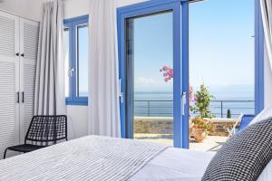 a bedroom with a bed and a view of the ocean at Villa Aless in Skopelos Town