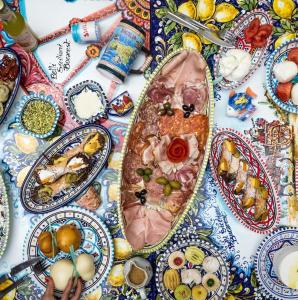 a table with plates of food on it at Belli Siciliani Bed&Breakfast in Bucharest