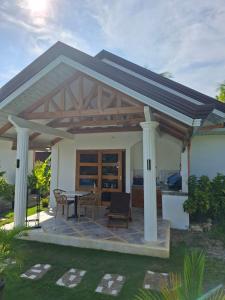 a pavilion with a table and chairs in a house at Buenacosa Resort in Panglao Island