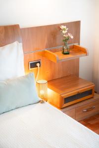 a bedroom with a bed and a vase with flowers on it at El BALCON DE BAKIO in Bakio