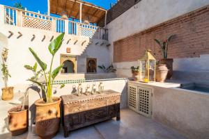 a bathroom with a sink and a potted plant at Marrakech Medina - Private Riad 4 rooms Rooftop and pools in Marrakesh +19 photos