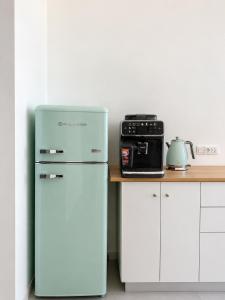 a white refrigerator in a kitchen with a microwave at Liolà Rooms in Terrasini