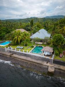 an aerial view of a resort with a swimming pool at Villa Seaview- tranquil 3BR, beachfront, private pool in Bukti