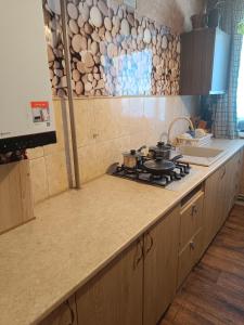 a kitchen with a stove with pots and pans on it at Jurmala-Sloka in Jūrmala