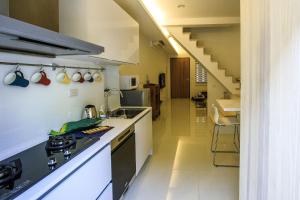 a kitchen with a sink and a stove top oven at 舒室民宿 in Tainan