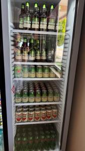 a refrigerator filled with lots of drinks at Hotel Engjell in Pogradec
